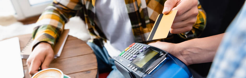 cropped view of man with credit card near waiter holding payment terminal, banner - Photo, Image