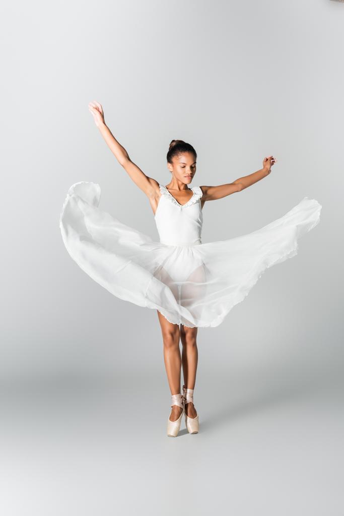 graceful african american ballerina in dress dancing on white background - Photo, Image