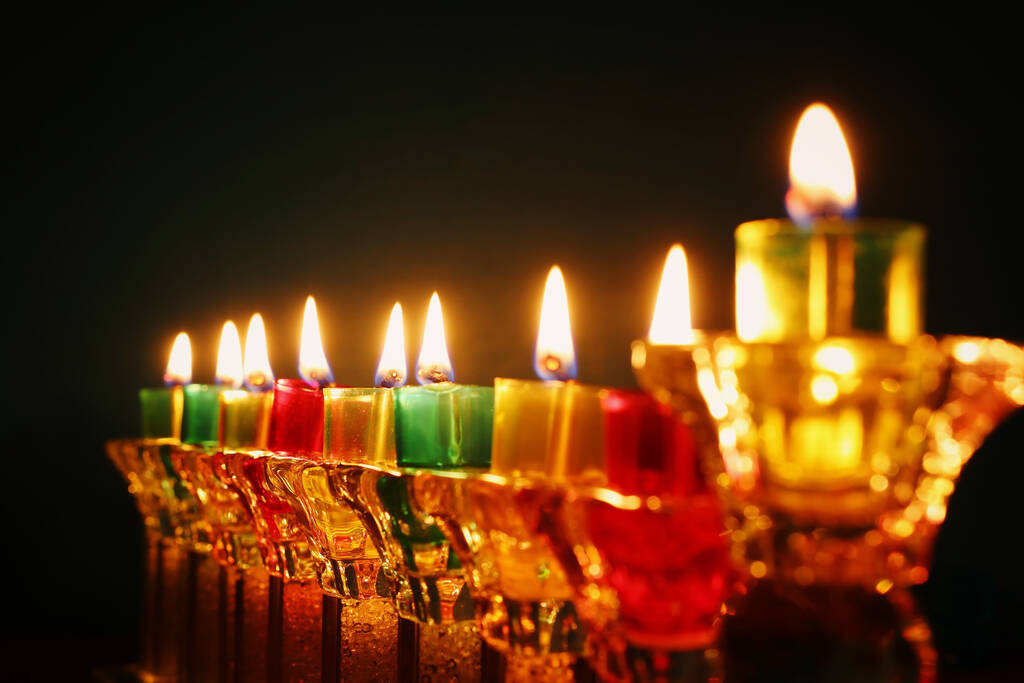 image of jewish holiday Hanukkah background with crystal menorah (traditional candelabra) and oil candles - Photo, Image