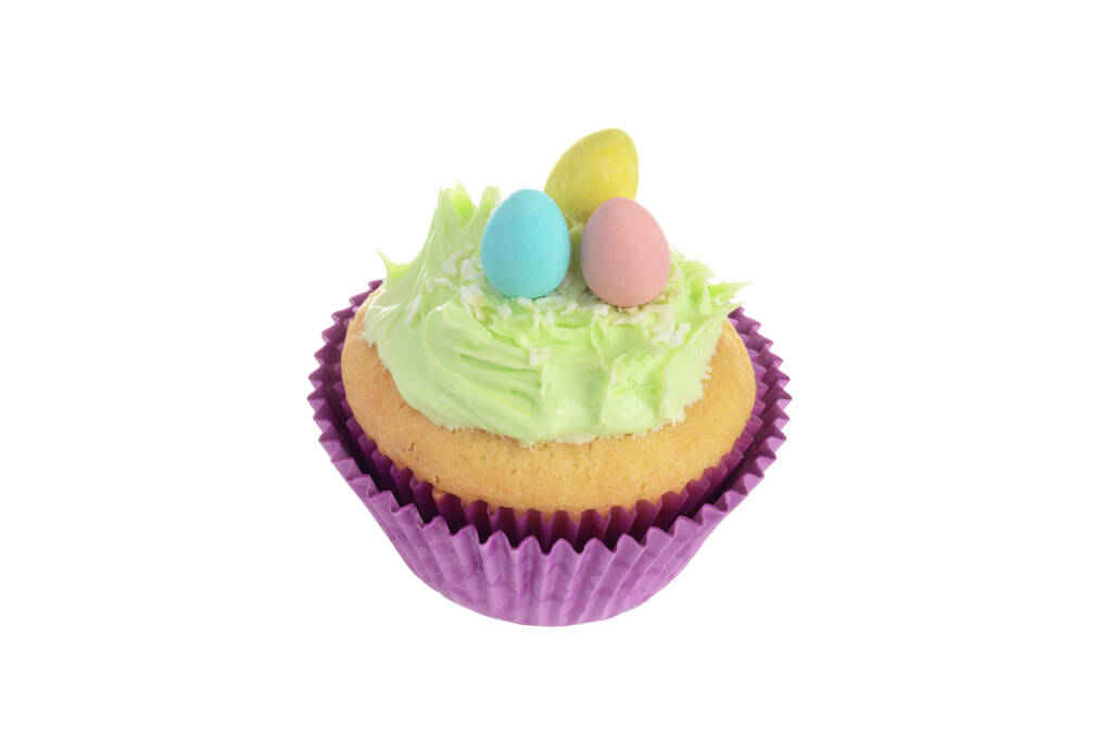  isolated easter cupcake with coconut frosting and mini chocolate eggs - Photo, Image