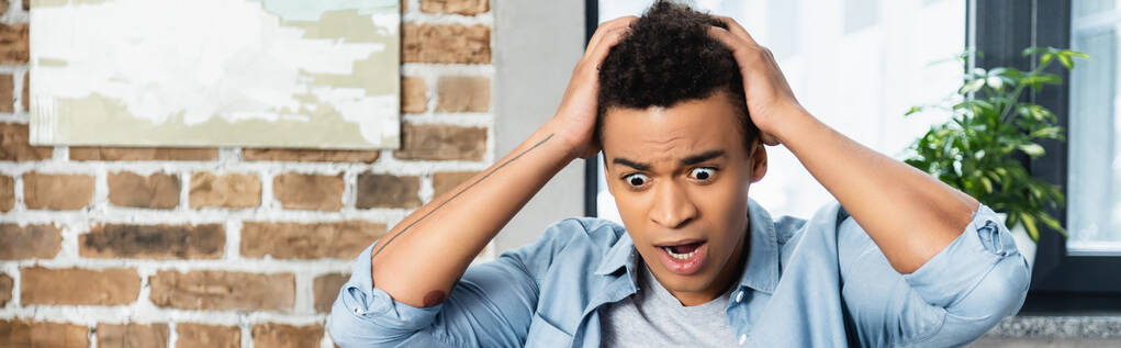 järkyttynyt nuori afrikkalainen amerikkalainen mies vetää hiukset, banneri - Valokuva, kuva
