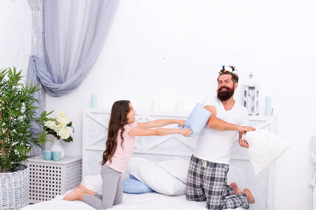 happy family of daughter and dad playing and fighting with pillows having fun together, happiness - Photo, Image
