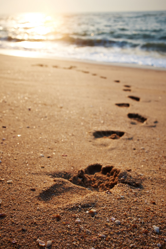 beach, wave and footsteps at sunset time  - Photo, Image