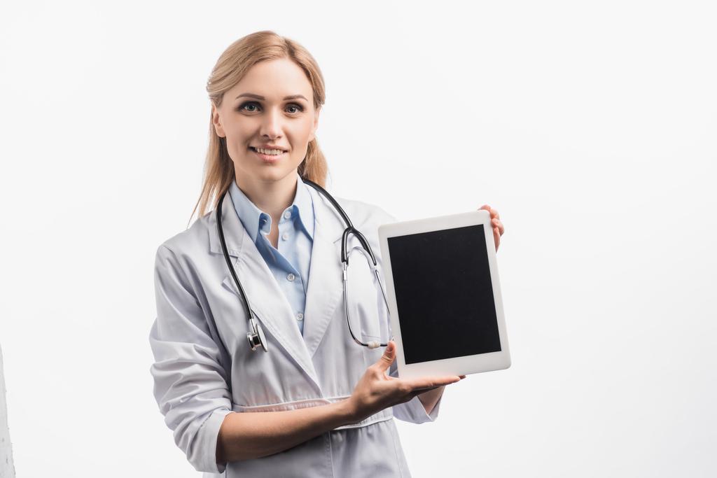 infirmière heureuse en manteau blanc tenant tablette numérique avec écran blanc isolé sur blanc - Photo, image