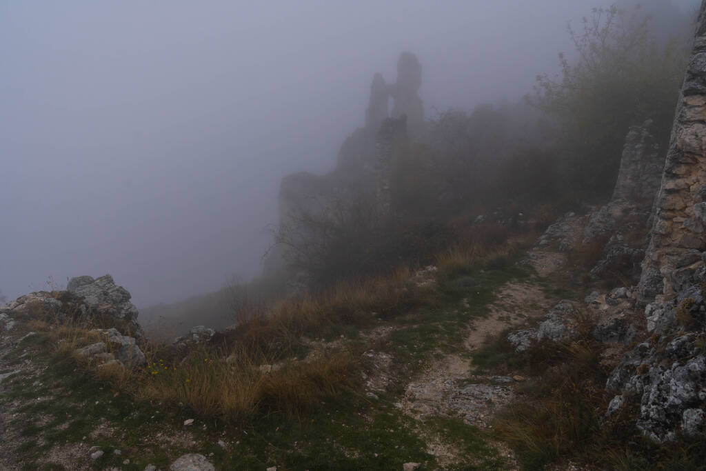 Bild von Ruinen einer mittelalterlichen Burg in Wolken und Nebel in Rocca Calasho, Abruzzen, Italien - Foto, Bild