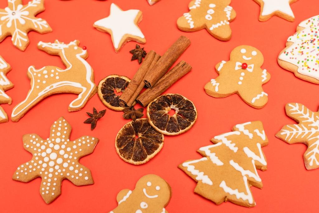 spices and gingerbread cookies on red background - Photo, Image