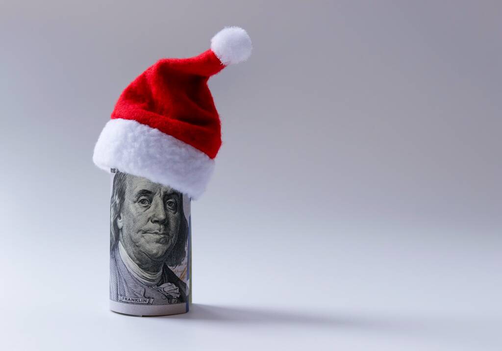 Santa's red cap is worn on a hundred-dollar bill rolled up with a picture of President Franklin. Free space for copying - Photo, Image