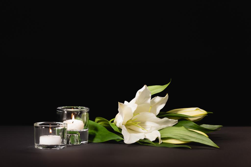 lily, candles on black background, funeral concept - Photo, Image