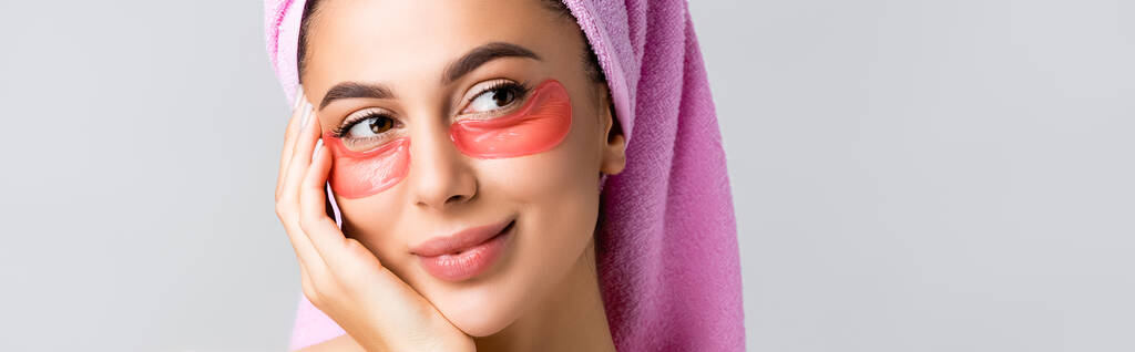 beautiful woman with towel on hair and hydrogel eye patches on face isolated on grey, banner - Photo, Image