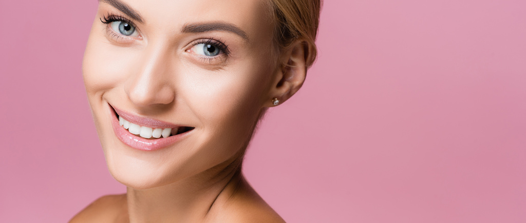 hymyilevä kaunis blondi nainen täydellinen iho eristetty vaaleanpunainen - Valokuva, kuva
