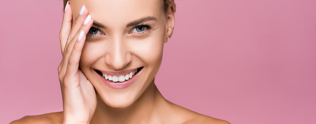 smiling beautiful blonde woman with perfect skin isolated on pink, banner - Photo, Image