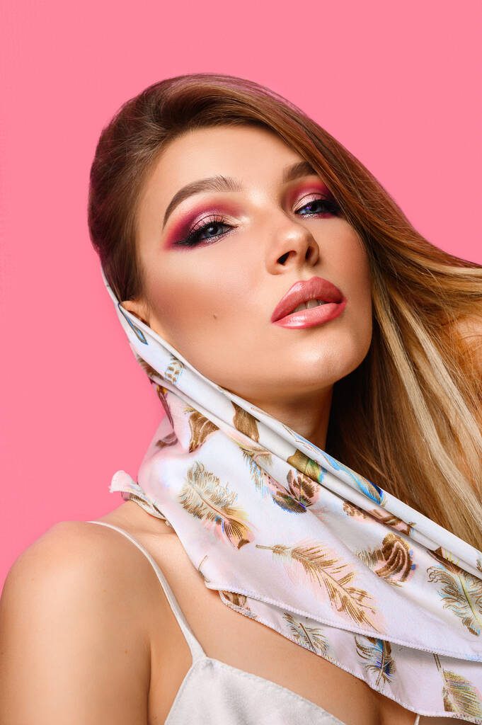 Fashionable, attractive girl in a scarf with bright pink makeup - Photo, Image