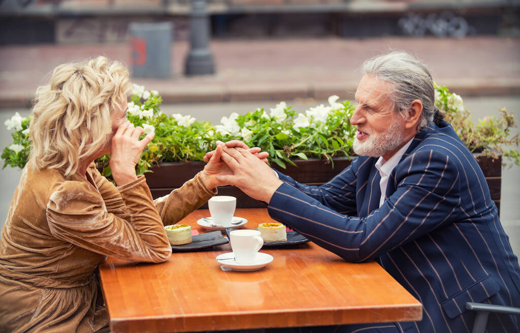 elderly couple sitting at the table - Photo, Image
