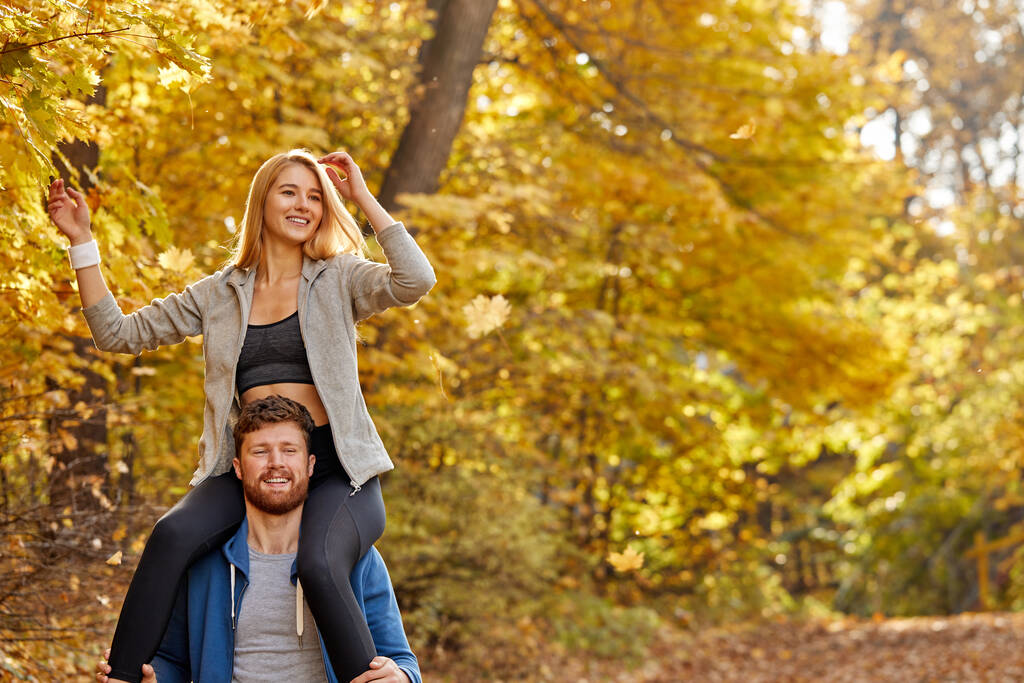 pareja alegre positivo pasar tiempo en el parque de otoño - Foto, Imagen