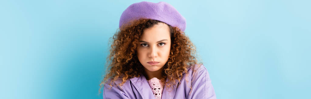 displeased woman in beret puffing cheeks on blue, banner - Photo, Image