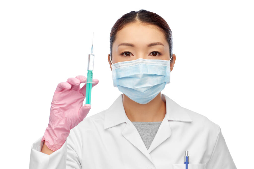 asian doctor in mask with medicine in syringe - Photo, Image