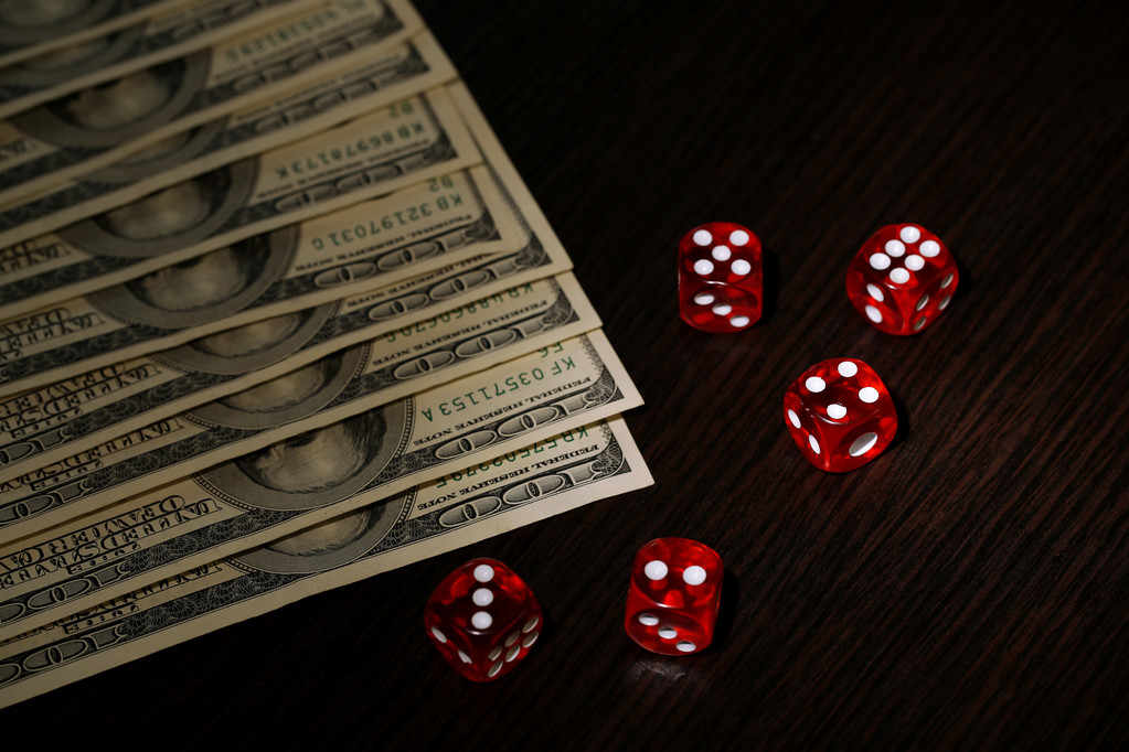 Red dices and dollars on wooden background - Photo, Image