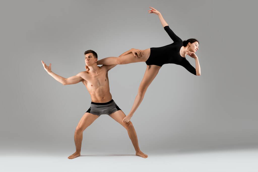 půvabný mladý pár dělá gymnastický cvičení spolu - Fotografie, Obrázek