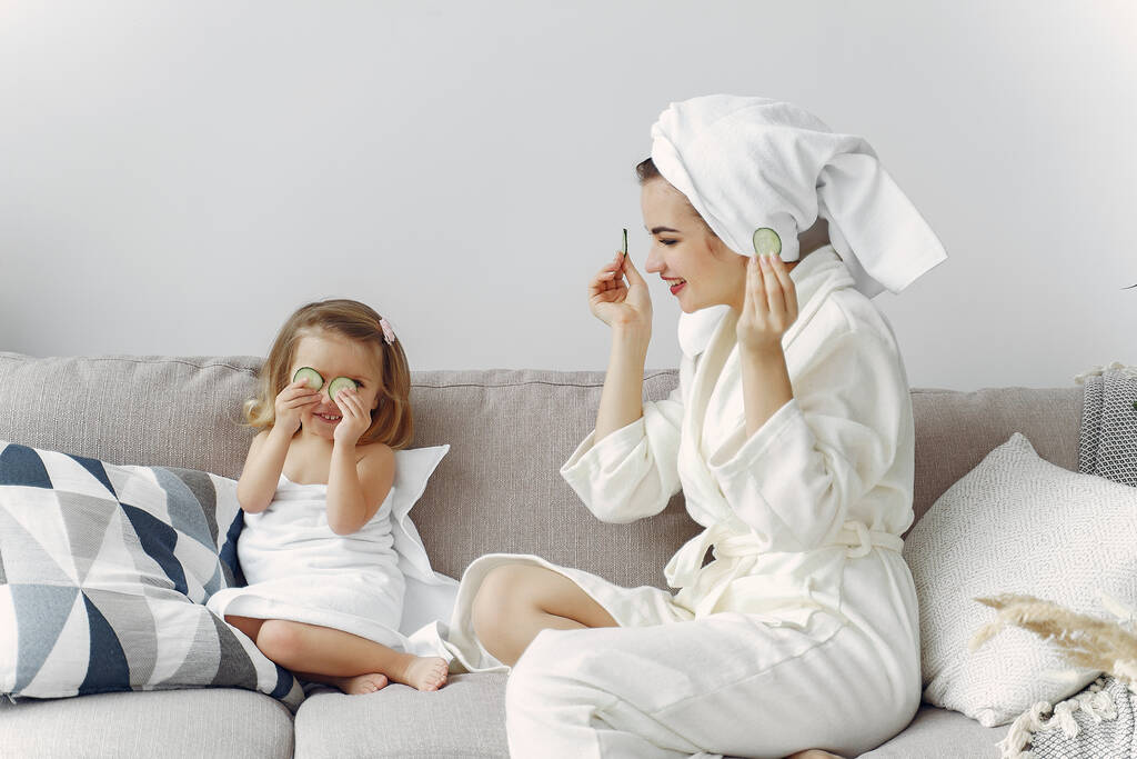 Mother with daughter in bathrobe and towels - Photo, Image
