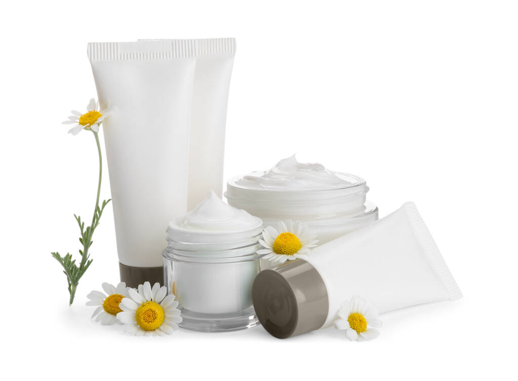 Σετ από διαφορετικά καλλυντικά προϊόντα και λουλούδια χαμομηλιού σε λευκό φόντο - Φωτογραφία, εικόνα