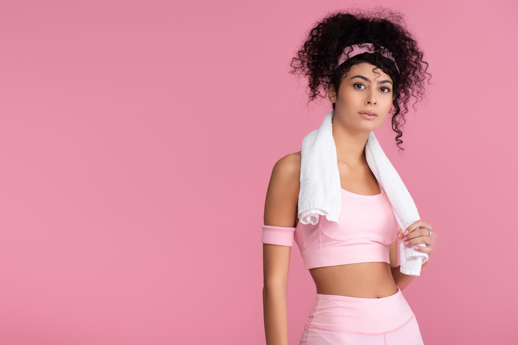 curly young sportswoman with towel on shoulders standing isolated on pink  - Photo, Image