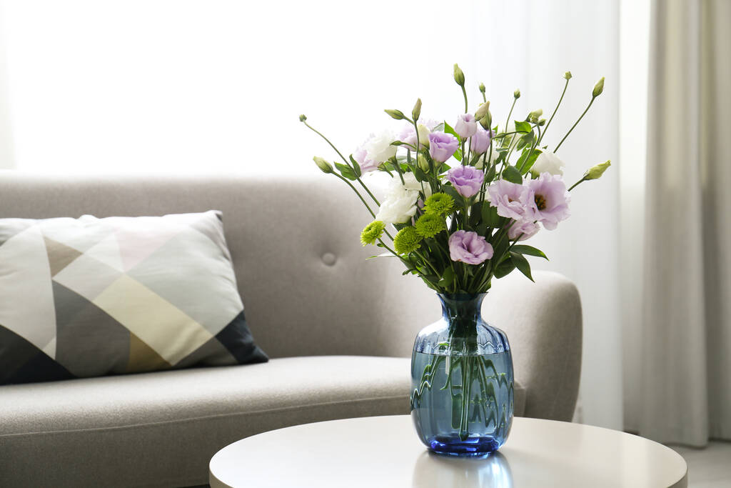 Bouquet of beautiful Eustoma flowers on table in room. Space for text - Photo, Image