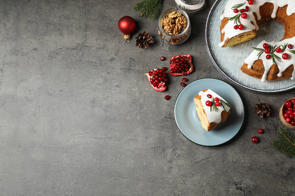 Flat lay composition with traditional homemade Christmas cake on grey table, space for text - Photo, Image