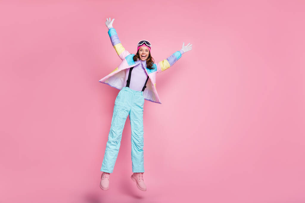Full length photo of charming lady snowboarder wear colorful coat eyewear jumping star isolated pink color background - Photo, Image