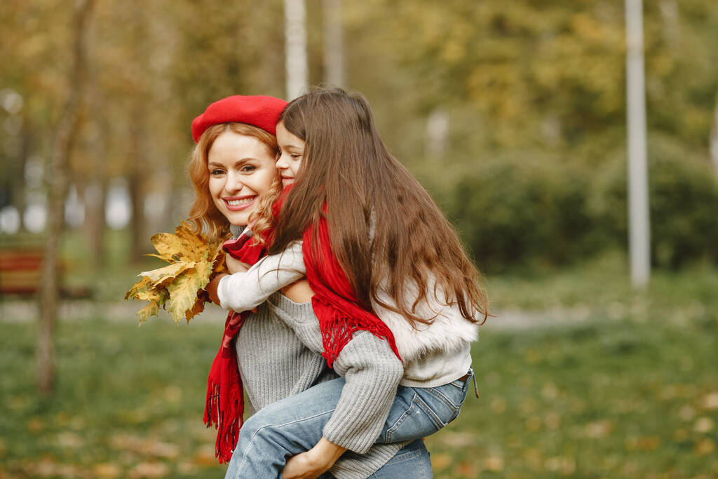 Cute and stylish family in a autumn park - Photo, Image