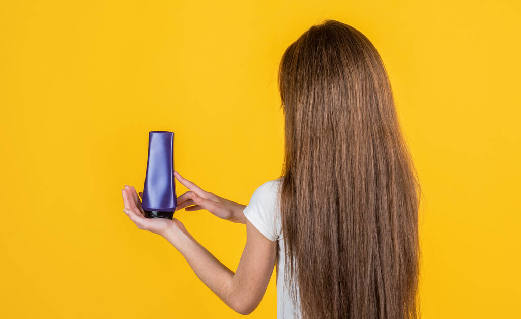 девушка-подросток мыть длинные прямые волосы с шампунем и кондиционером, парикмахер - Фото, изображение