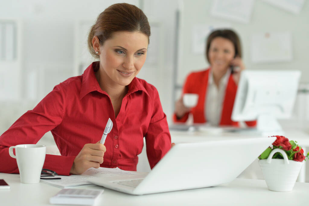 businesswoman architect working in modern office with her colleague on background - Photo, Image