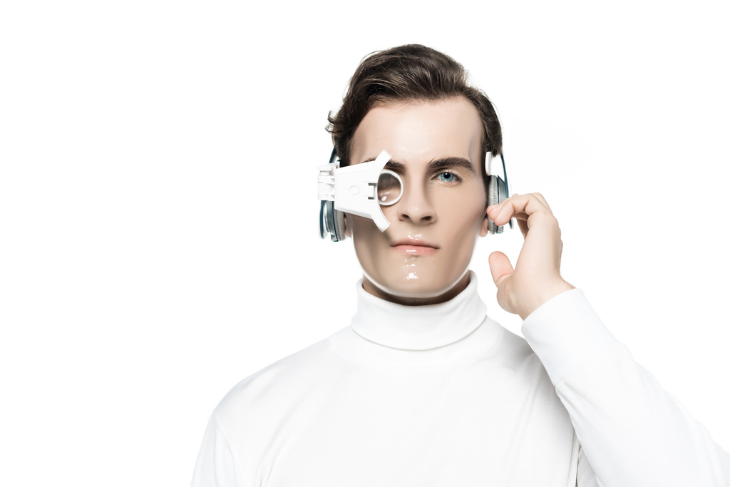 Cyborg σε ψηφιακό φακό μάτι αγγίζοντας ακουστικά και κοιτάζοντας κάμερα που απομονώνονται σε λευκό - Φωτογραφία, εικόνα