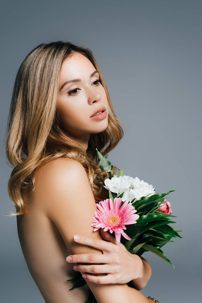 charming, topless woman posing with flowers isolated on grey - Photo, Image