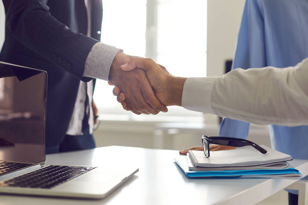 Businessman shaking hands with his client, confirming their business cooperation - Photo, Image