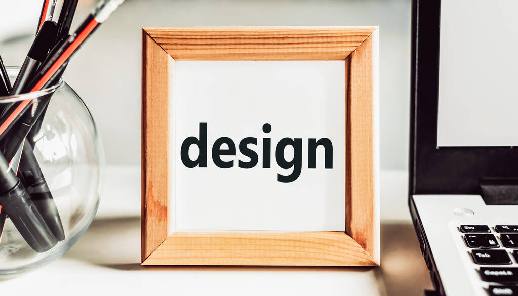 DESIGN text in a wooden frame on an office table. - Photo, Image