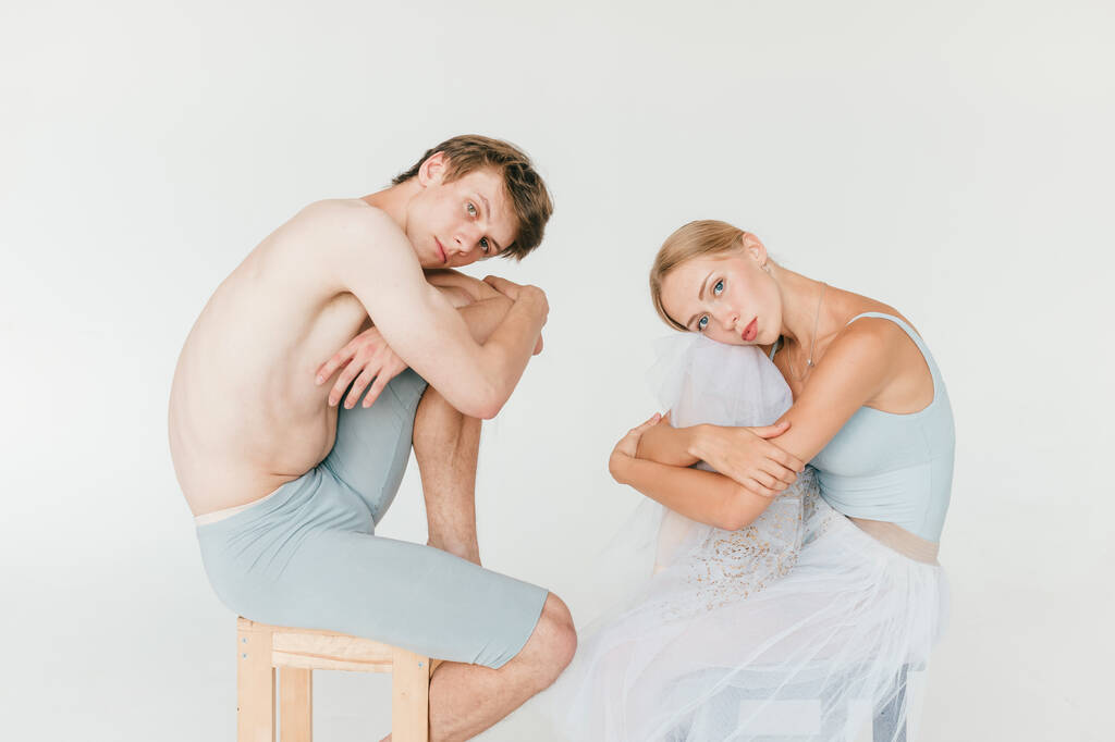 Beautiful couple of ballet dancers lifestyle portrait over white studio background - Photo, Image