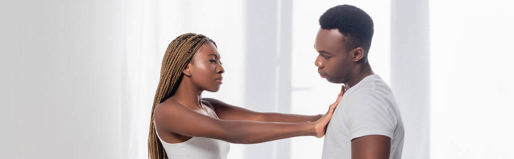 African american woman pushing back boyfriend while quarreling at home, banner  - Photo, Image