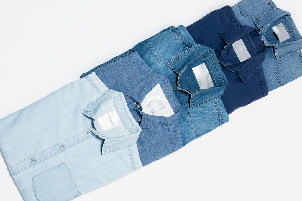 top view of various denim shirts on white background - Photo, Image