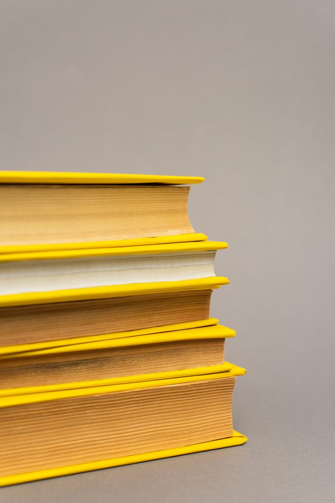 stack of yellow notebooks isolated on grey - Photo, Image