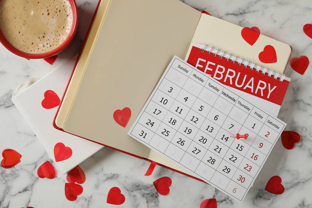 Calendário com marcado Dia dos Namorados, cadernos e xícara de café em mesa de mármore branco, flat lay - Foto, Imagem