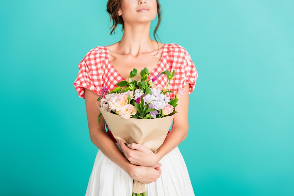 partial view of woman in stylish retro clothes holding bouquet isolated on turquoise - Photo, Image