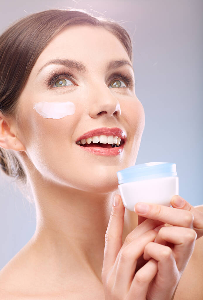 close up beauty portrait of smiling woman looking up holding jar cream. Face portrait. - Photo, Image