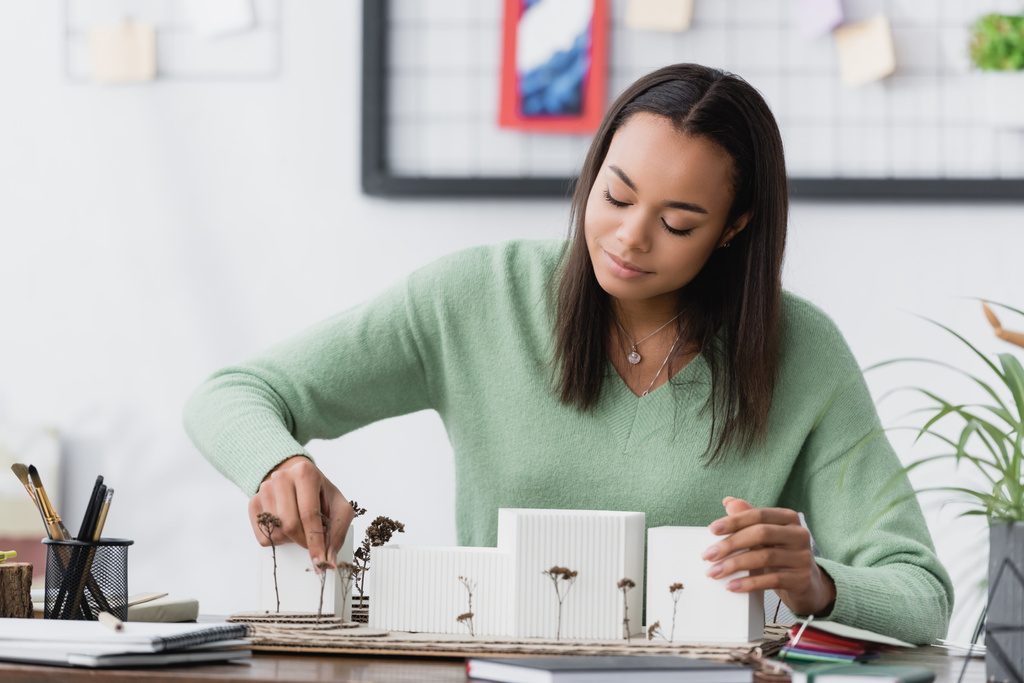 positive african american architect making buildings maquette at home studio - Photo, Image