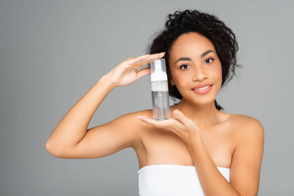 African american woman holding cleansing foam isolated on grey  - Photo, Image