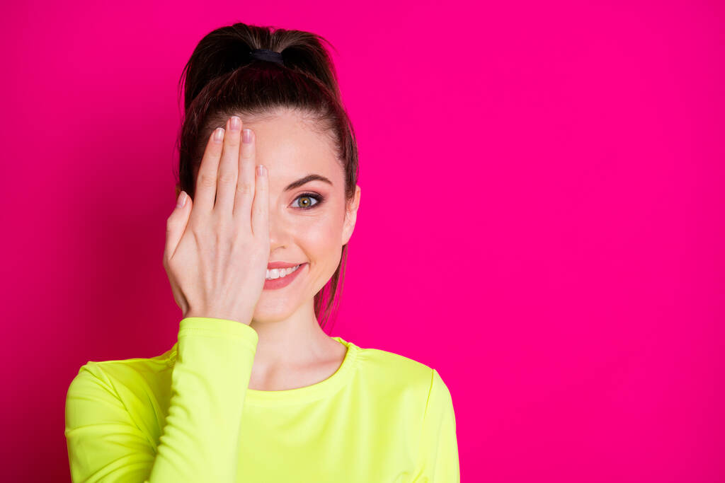 Photo of young positive sportswoman cover hand eye face isolated over bright pink color background - Photo, Image