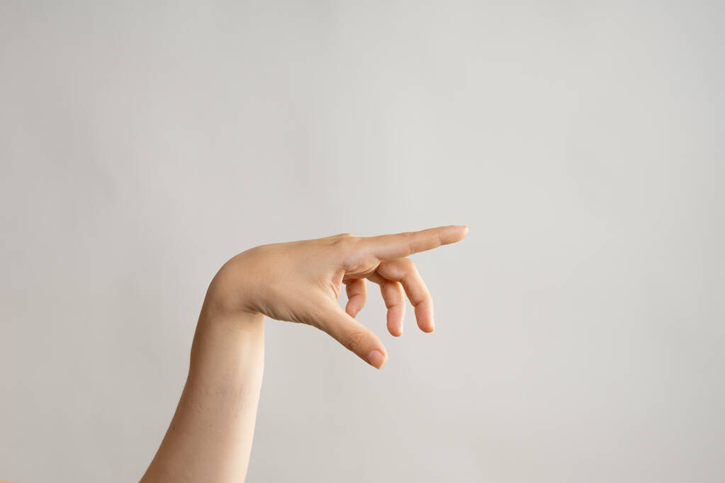 Hand gestures. Poke your finger, point to the side. Womens hand - Photo, Image