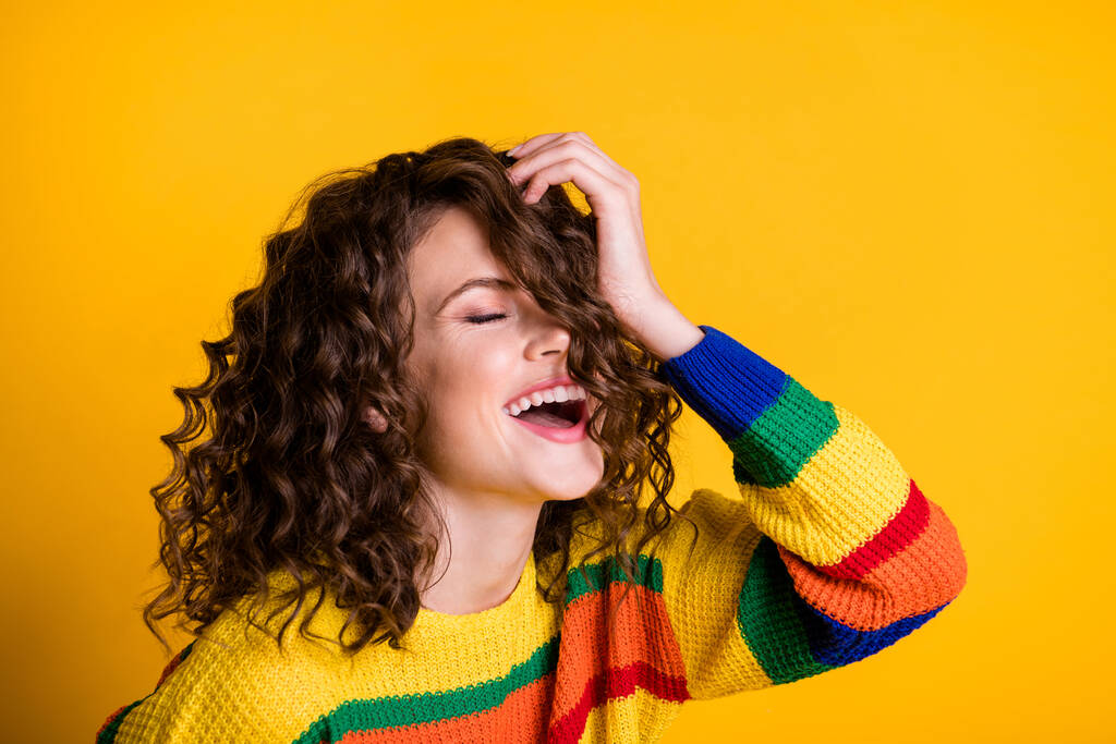 Photo of funny positive woman dressed casual colorful pullover closed eyes arm head isolated yellow color background - Photo, Image
