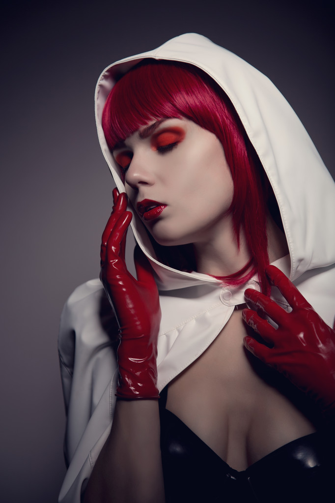 Portrait of mysterious sensual woman wearing white hooded jacket - Photo, Image