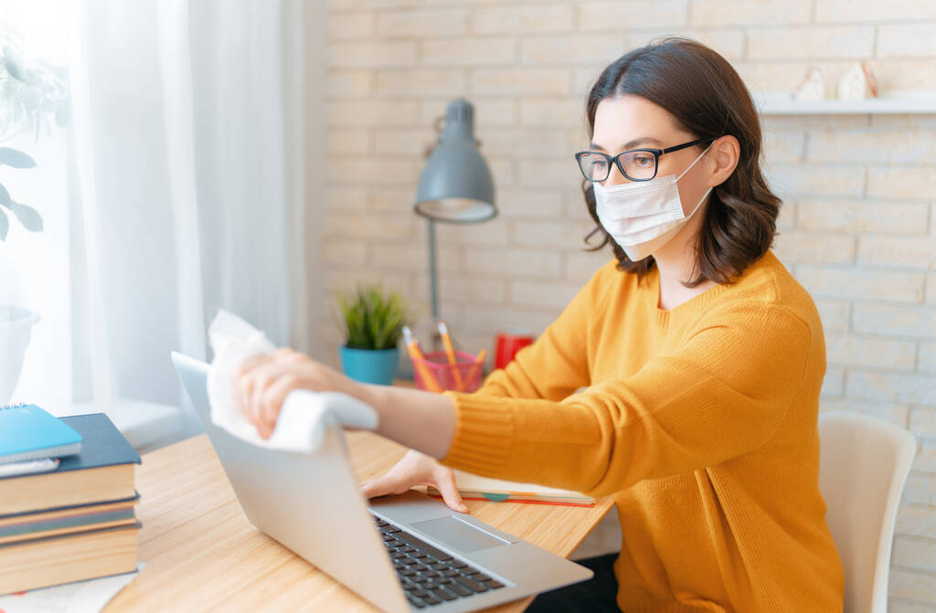 Woman in facemask working in home office. - Photo, Image