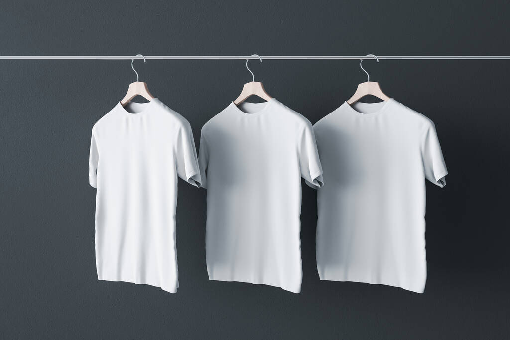 Пофарбуйте свою концепцію знаку трьома порожніми білими футболками, що звисають на звичайній темній стіні. Макет. 3D візуалізація
 - Фото, зображення